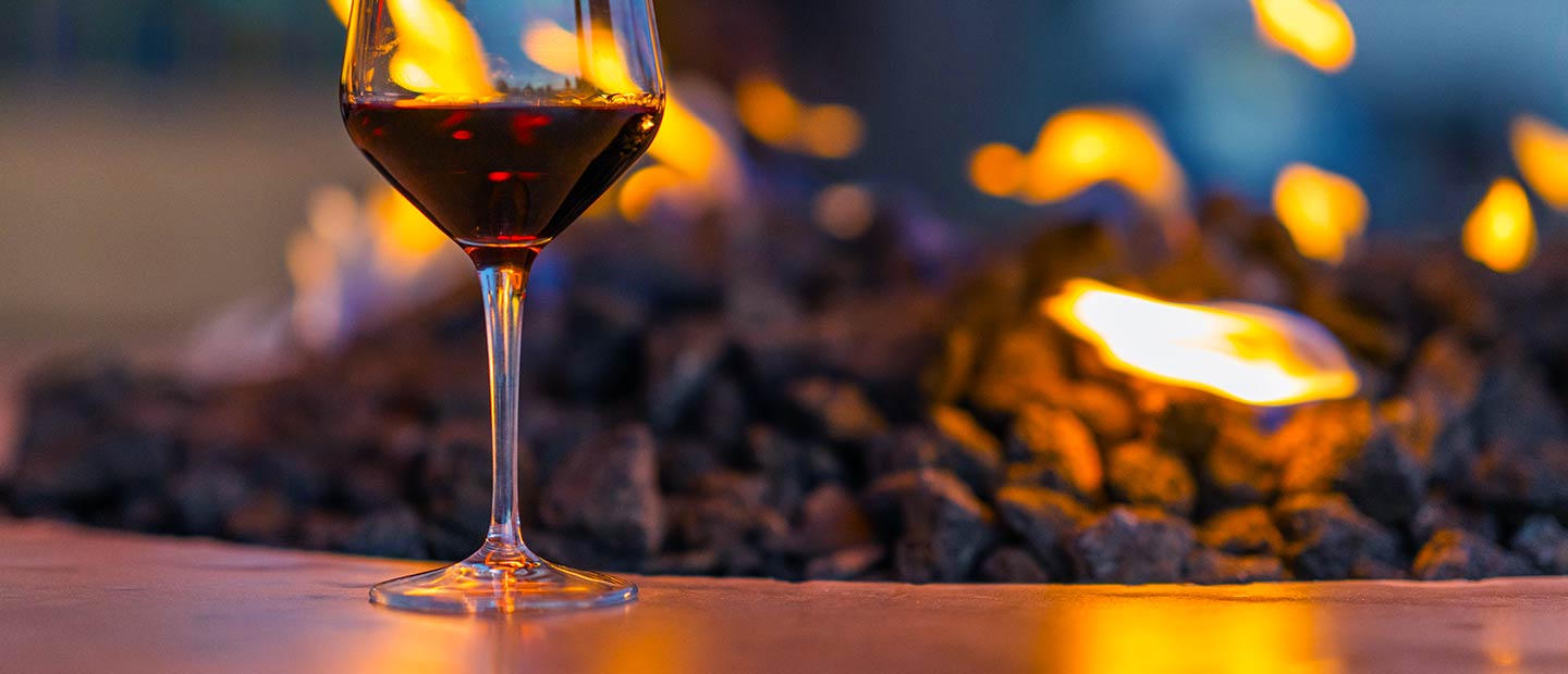 embers terrace fire pit with wine glass half full