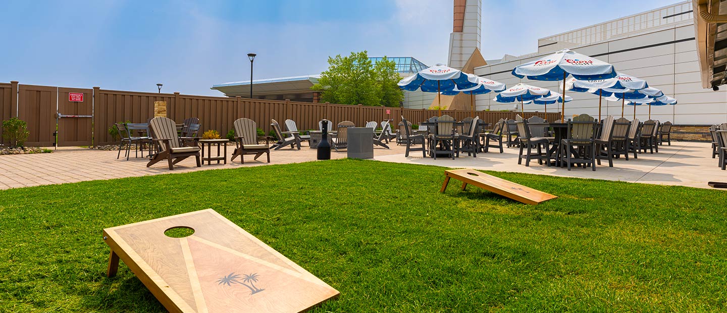 embers terrace lawn shot with cornhole setup